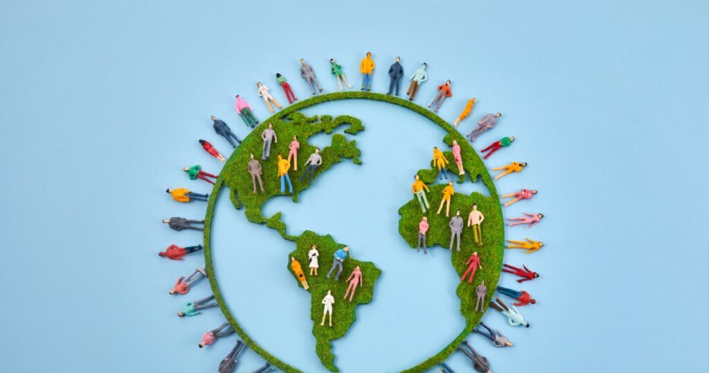 Circular economy concept with miniature figures on a globe