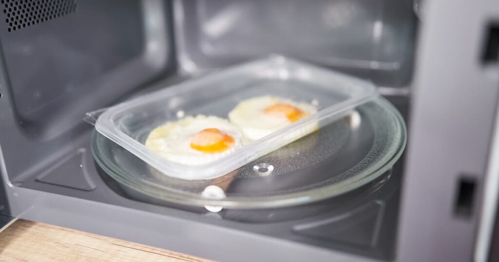 Food in plastic packaging inside a microwave