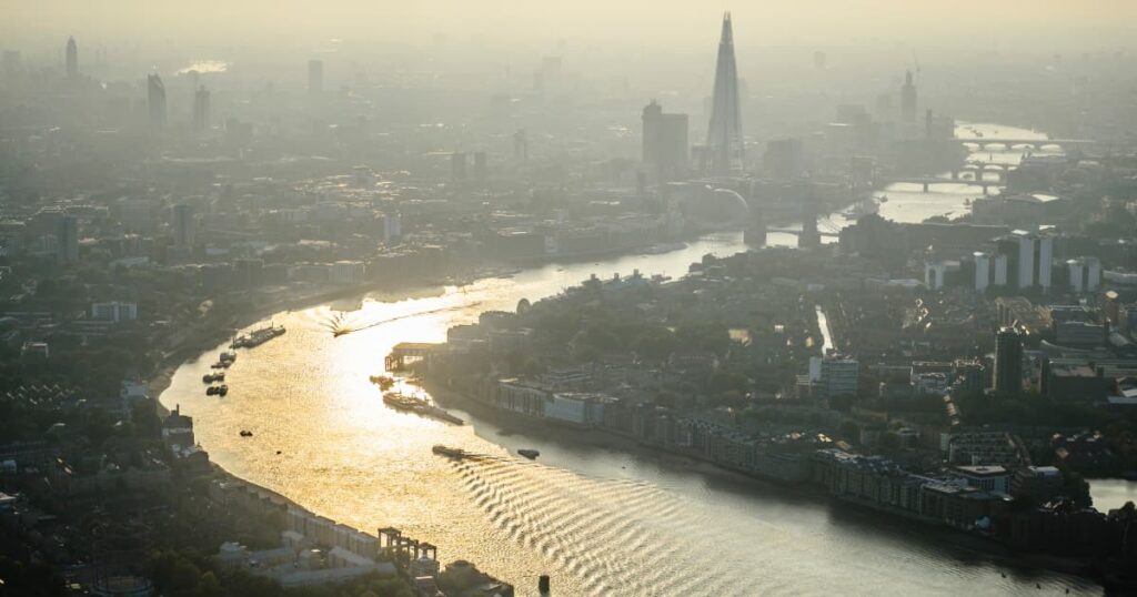 Aerial view of London with smog over the Thames River